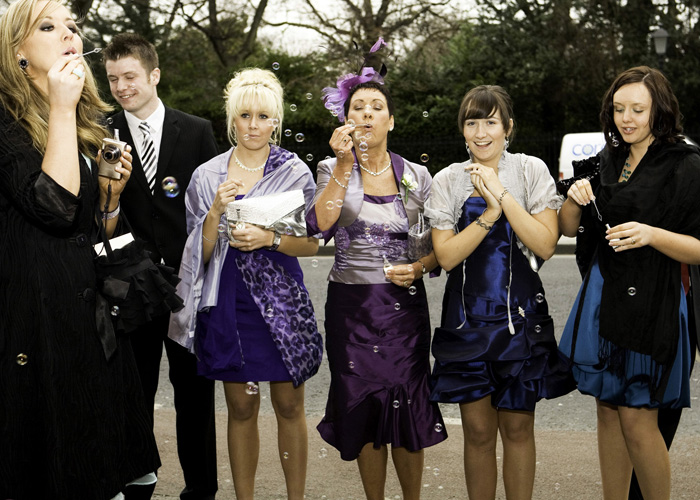 wedding party blowing bubbles